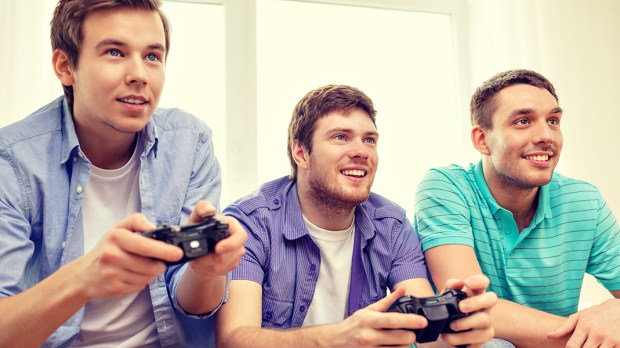 WEB3 TEENAGER TEENS BOYS PLAYING VIDEO GAMES COUCH CONTROLLER Shutterstock