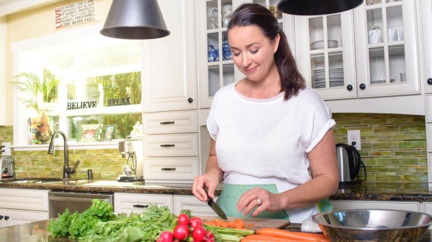 WEB3 WOMAN COOKING KITCHEN ISLAND FOOD SALAD HEALTHY Shutterstock
