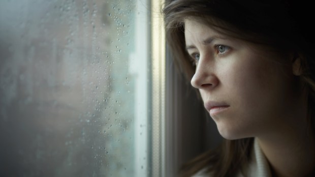 web3-woman-depressed-depression-sad-alone-lonely-window-rain-darkness-shutterstock