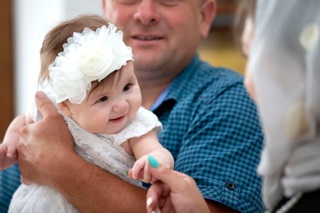 baby at baptism with godparents
