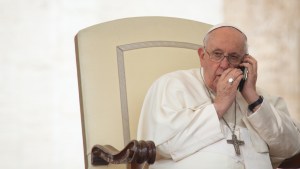 Pope Francis speaks on the phone during the weekly general audience