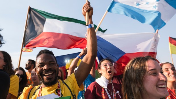 Pilgrims pray during the World Youth Days vigil with young people in Tejo Park, Lisbon